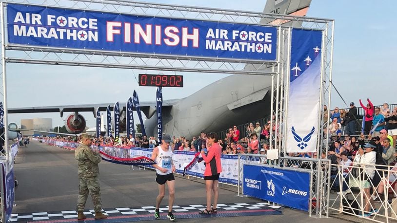 John Mascari of Westfield, Ind. breaks the tape to win the men's half-marathon Saturday at Wright Patterson Air Force Base. Tom Archdeacon/CONTRIBUTED