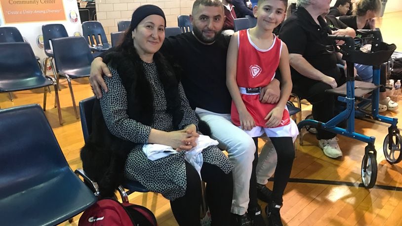 Turkish boxer Aydin Idrisov sits with his mom, Shura, and his dad, Ismail, after his bout on Sunday. Tom Archdeacon/CONTRIBUTED