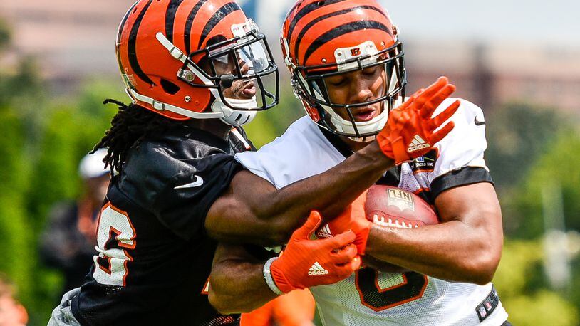 Cornerback Josh Shaw, left, tries unsuccessfully to defend a catch by wide receiver Tyler Boyd during the first day of Cincinnati Bengals Training Camp Friday, July 28 at the practice fields beside Paul Brown Stadium in Cincinnati. NICK GRAHAM/STAFF