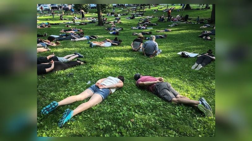 Protesters in Bellbrock Park spent almost nine minutes on their stomachs Friday night, June 5, 2020, to mark the time a police officer's knee was on George Floyd's neck. JIM NOELKER/STAFF