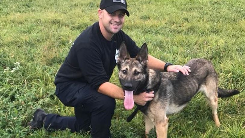 The Colerain Township newsletter posted this picture of Robert Brinkman and his K-9 partner, Tao, on Oct. 5, 2017. Brinkman, a Liberty Twp. resident, was indicted Thursday by a Butler County grand jury on sex charges involving a minor. (COURTESY/COLERAIN TWP.)