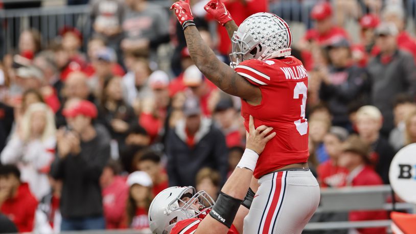 Ohio State running back Miyan Williams, top, celebrates his touchdown against Rutgers with teammate offensive lineman Matthew Jones during the first half of an NCAA college football game, Saturday, Oct. 1, 2022, in Columbus, Ohio. (AP Photo/Jay LaPrete)