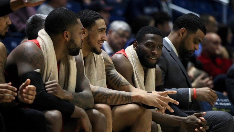 Dayton’s Trey Landers, Obi Toppin and Jalen Crutcher talk on the bench late in a victory against Rhode Island on Wednesday, March 4, 2020, at the Ryan Center in Kingston, R.I. David Jablonski/Staff