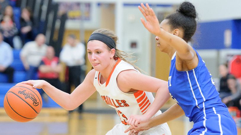 Versailles junior guard Ellen Peters dribbles with pressure from Summit County Day’s Alea Harris during a Division III regional final on Saturday at Springfield High School. BRYANT BILLING / CONTRIBUTED