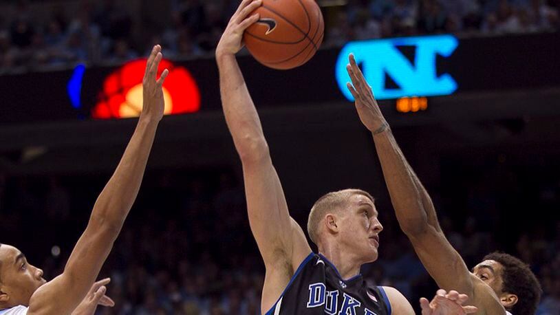 Duke's Mason Plumlee (5) puts up a hook shot over North Carolina's James Michael McAdoo in the second half on March 9, 2013, at the Smith Center in Chapel Hill, N.C. (Robert Willett/Raleigh News & Observer/TNS)