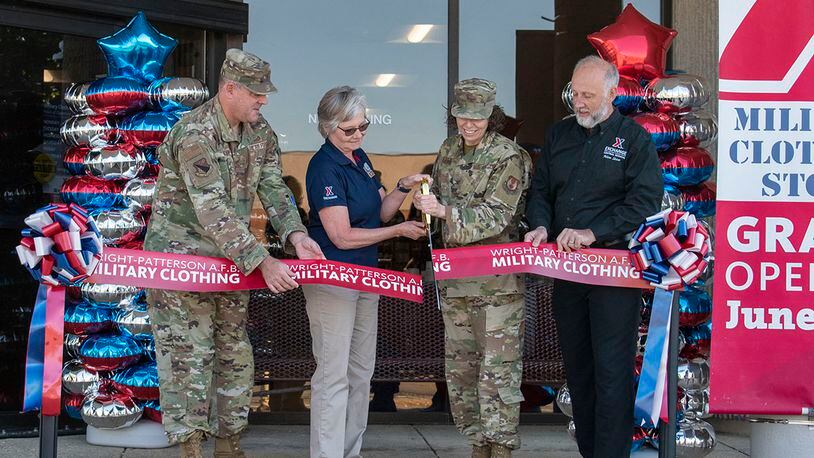 Col. Sirena Morris, 88th Mission Support Group commander, cuts the ribbon on the new location of Military Clothing Sales during its reopening ceremony June 30 at Wright-Patterson Air Force Base. She was joined by installation leaders and Army & Air Force Exchange Service managers.  The store was relocated to provide ease of access for Airmen and retirees looking to purchase military clothing items. U.S. AIR FORCE PHOTO/STAFF SGT. MIKALEY KLINE