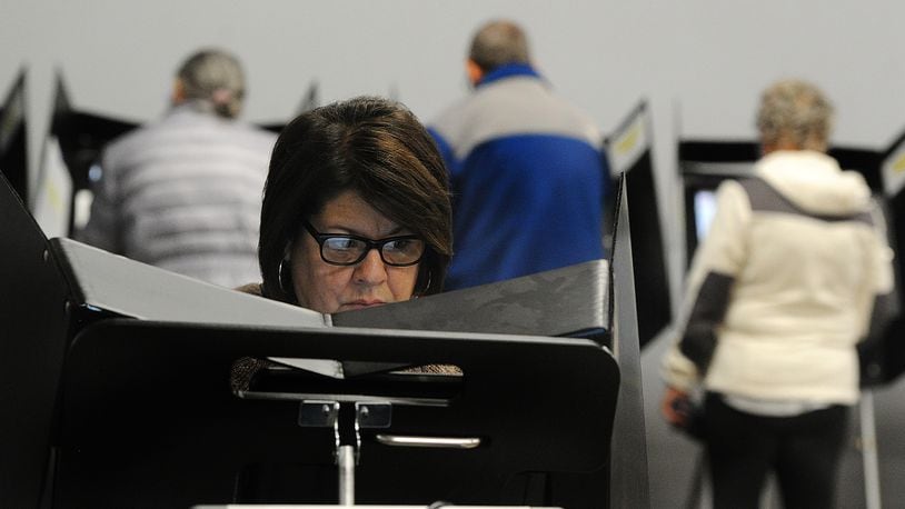 Annette LaCivita reads the ballot while doing in-person early voting Friday, Nov. 3, 2023 at the Greene County Board of Elections in Xenia. MARSHALL GORBY\STAFF