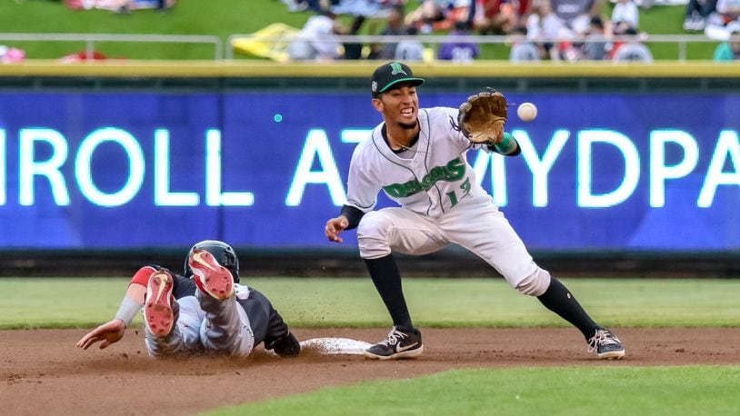 Dayton Dragons shortstop Miguel Hernandez waits for the ball as the Lansing Lugnuts’ Griffin Conine slides back into second base after a pick-off attempt by catcher Jay Schuyler during their game on Thursday night at Fifth Third Field. The Dragons won 7-2. CONTRIBUTED PHOTO BY MICHAEL COOPER