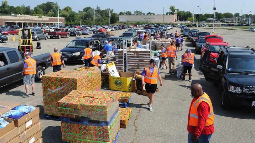The Foodbank Drive-Thru operates drive-thru food distributions two days a week. During a distribution at the old Salem Mall in Trotwood in September, guests received fresh produce, proteins, grains and other products free of charge. MARSHALL GORBY\STAFF
MARSHALL GORBY\STAFF