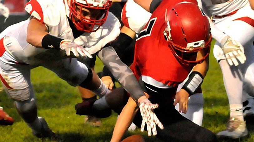 Madison’s Mason Whiteman (7) recovers his own fumble during the second quarter of a Southwestern Buckeye League game against Carlisle on Oct. 7. CONTRIBUTED PHOTO BY DAVID A. MOODIE