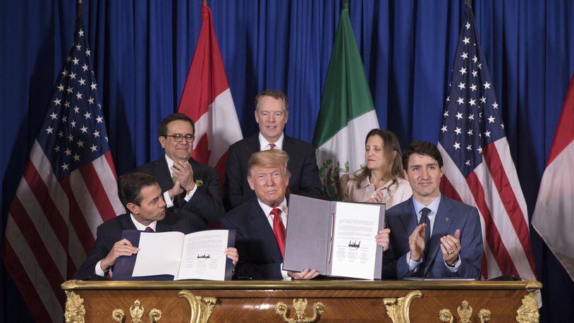 President Enrique Peña Nieto of Mexico, President Donald Trump and Prime Minister Justin Trudeau of Canada sign a new free trade agreement, called the United States-Mexico-Canada Agreement, on the sidelines of the G-20 summit in Buenos Aires, Argentina, Nov. 30, 2018. The USMCA deal replaces the North American Free Trade Agreement, or NAFTA. (Tom Brenner/The New York Times)