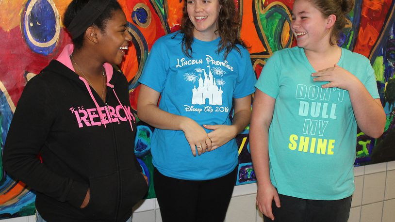 Lincoln Elementary students (left) Diondraya Beal and (right) Tearsa Gilbert discuss with (center) Megan Detrick what they want to see and do when they get to Walt Disney World. JEFF GUERINI/STAFF