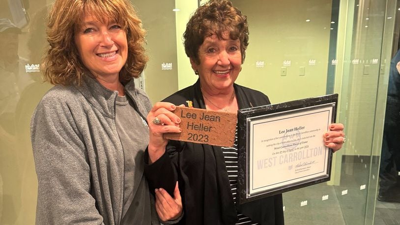 Lee Jean Heller (right) and her daughter, Stacey Swank, emerge from a West Carrollton City Council meeting after Heller was inducted into the West Carrollton Plaza of Fame Tuesday, April 9, 2024. The annual award recognizes current or former residents for making the city a better place to live and work. CONTRIBUTED