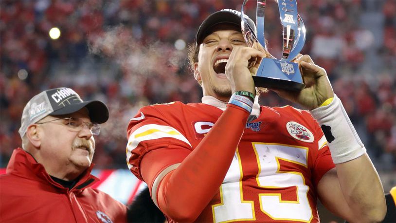 Kansas City Chiefs quarterback Patrick Mahomes holds the Lamar Hunt Trophy as he celebrates winning the AFC Championship Game.