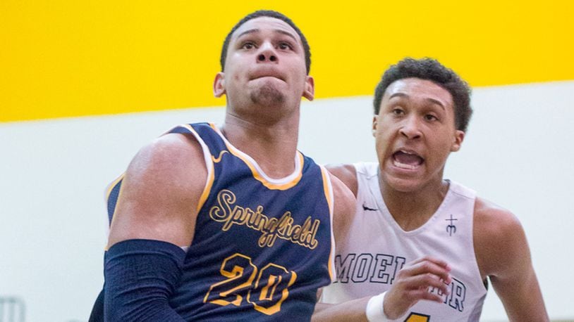 Springfield junior forward Leonard Taylor shoots with pressure from Moeller’s Jeremiah Davenport during a nonconference game on Saturday night. Contibuted Photo by Bryant Billing