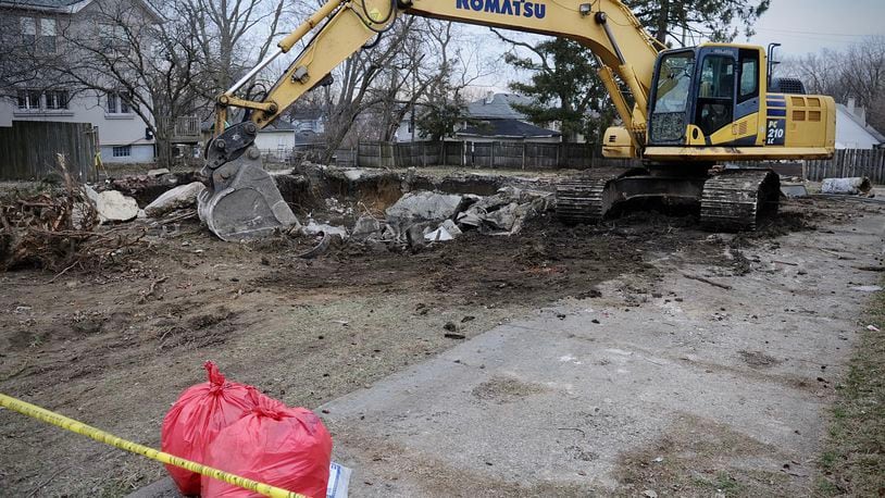 Crews excavating a torn down house in the 1300 block of Huffman Avenue in Dayton found a body in the basement, police said. MARSHALL GORBY \STAFF