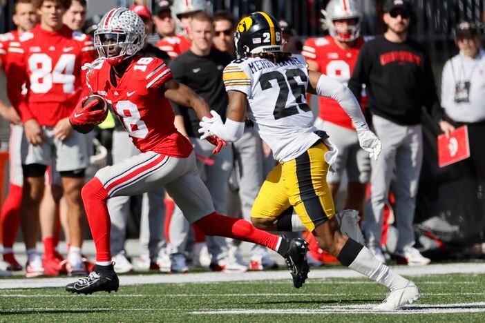 Ohio State receiver Marvin Harrison, left, cuts up field against Iowa defensive back Kaevon Merriweather during the second half of an NCAA college football game Saturday, Oct. 22, 2022, in Columbus, Ohio. (AP Photo/Jay LaPrete)
