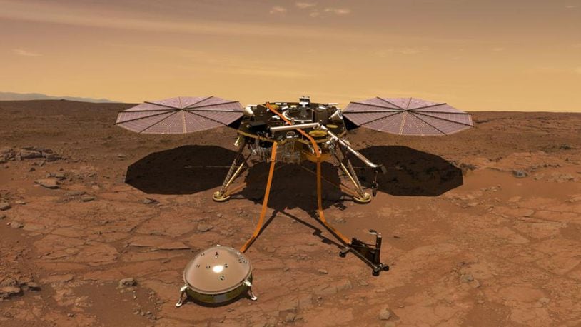 An artist’s drawing of the InSight Mars lander at work on the Red Planet with it’s science instruments deployed to measure marsquakes and interior composition and temperature.