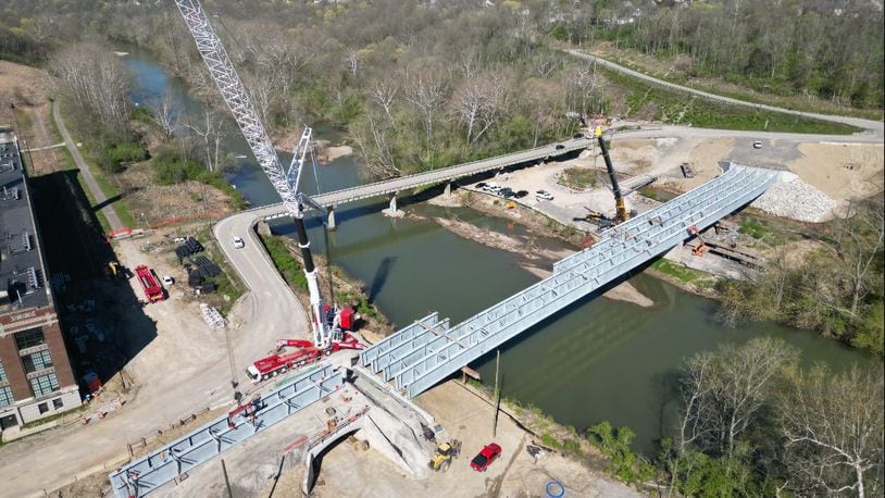 This is a view of the new King Avenue Bridge construction over Little Miami River. The new $22 million bridge and road project will have a two-lane configuration, but the lanes will be widened, and safety shoulders will be added in both directions. The new structure will be built upstream of the existing bridge crossing. In addition, a new 10-foot multi-use path will be built on the new bridge that will separate pedestrians from traffic, and a tunnel will be built for a portion of the Little Miami Scenic Bike Trail, which will separate the trail from Grandin Road. The old bridge will be demolished in the coming months. CONTRIBUTED: WARREN COUNTY ENGINEER'S OFFICE AND OHIO UAS CENTER