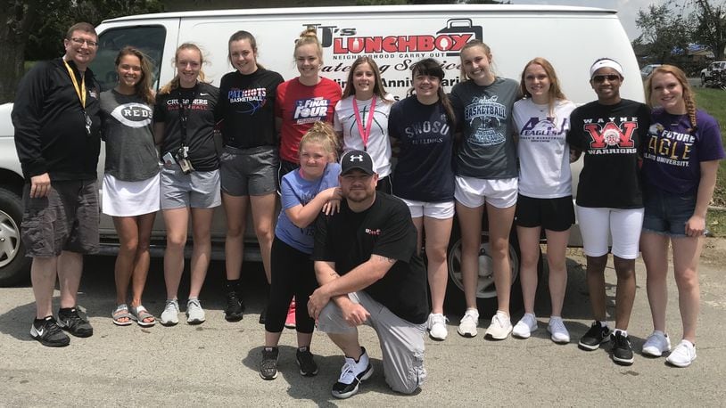 A group of local basketball players pose for a photo after handing out hot meals in the Shiloh Gardens neighborhood in Trotwood six days after the Miami Valley tornadoes. Back row (left to right): Jim Dabbelt, Rosie Westerbeck, Allie Downing, Meghan Downing, Maddie Downing, Haleigh Mayo-Behnken, Lauren Hapgood, Callie Hunt, Sam Chable, Nyla Hampton, Shannon Chable. Front row: Kennedy Pierce, Jason Pierce. Submitted photo