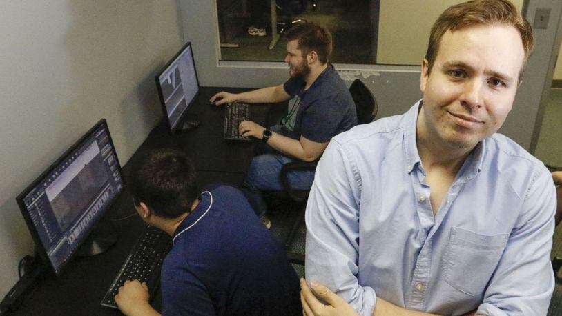 Kyle Barton, standing, who is on the autism spectrum, is a graduate and instructor at the nonPareil Institute in Plano, Texas. The institute is a non-profit that helps adults with autism through technical, vocational and social training. Shown on Wednesday May 2, 2018 are Iain Morrison, front, and Jake Raybon in the Unreal World Builder I class, where students learn a software used to create video games. (Ron Baselice/ Dallas morning News/TNS)