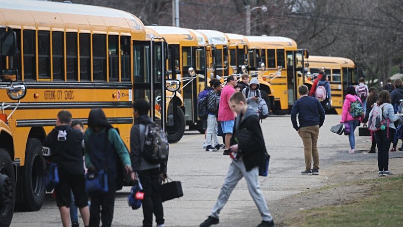 Ohio Gov. Mike DeWine ordered closure of public schools for three weeks, beginning next week, to slow the spread of coronavirus. Here, Kettering students board buses Thursday at Van Buren Middle School. MARSHALL GORBYSTAFF