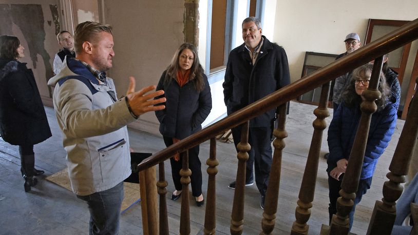 Jamon Sellman, the owner of the Willman Building in downtown Urbana, gives a tour of the second floor of the building Friday, Dec. 8, 2023 following a groundbreaking event for the redevelopment of the former furniture store into a Willwork Coworking space and living space. BILL LACKEY/STAFF