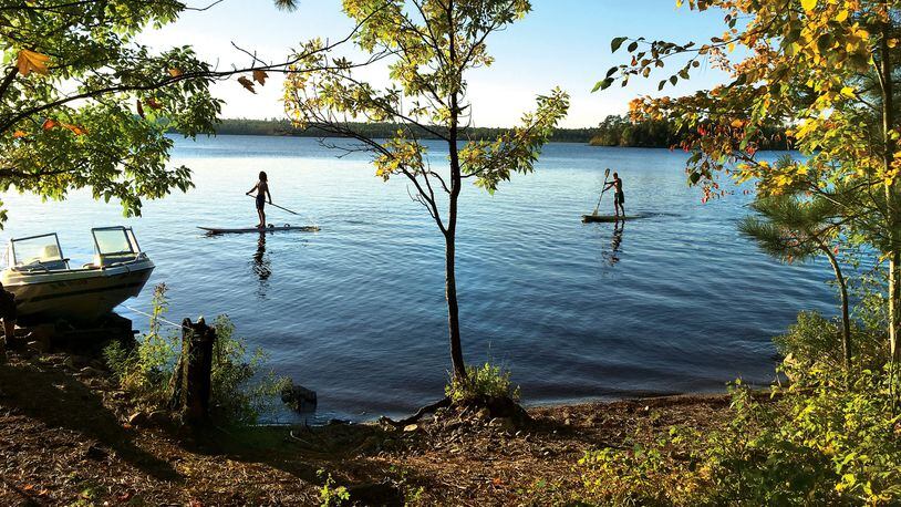 During the first day at the lodge, Brothers Nathan (left) and Gabe Usem broke out the paddle boards on White Iron Lake. Their family was visiting from California. (Jenna Ross/Minneapolis Star Tribune/TNS)