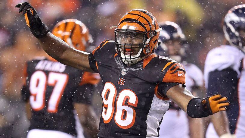 CINCINNATI, OH - DECEMBER 22: Carlos Dunlap #96 of the Cincinnati Bengals celebrates after sacking Peyton Manning #18 of the Denver Broncos during the fourth quarter at Paul Brown Stadium on December 22, 2014 in Cincinnati, Ohio. Cincinnati defeated Denver 37-28. (Photo by Andy Lyons/Getty Images)