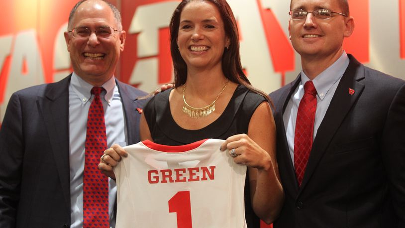 Dayton President Eric F. Spina, women’s basketball coach Shauna Green and Athletic Director Neil Sullivan pose for a photoat a press conference where Green was introduced as Dayton women’s basketball coach on Wednesday, Sept. 14, 2016, at UD Arena. David Jablonski/Staff