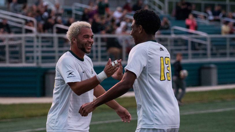 Wright State’s Austin Kinley (left) and Alex Phillipe celebrate after Phillipe’s goal against Duquense on Sept. 25, 2018. Joseph Craven/CONTRIBUTED