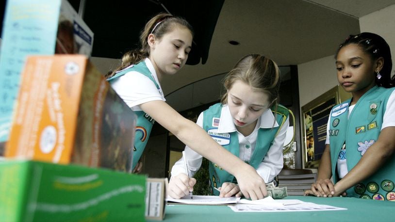 A group of Girl Scouts fills out an order form while selling Girl Scout cookies Feb. 23, 2007, in Dallas. A Girl Scout was assaulted Saturday, Feb. 16, 2019, as she sold cookies outside a Redding, California, Walmart, police said.