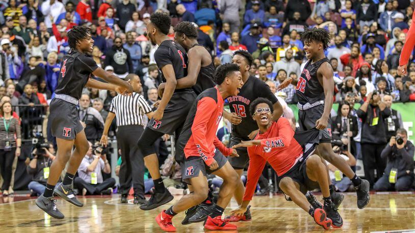 The Trotwood-Madison High School boys basketball team celebrates as the buzzer sounds at the Division II state championship game at the Ohio State University Jerome Schottenstein Center in Columbus. Trotwood-Madison beat Columbus South 77-73 to win its first boys basketball state championship.