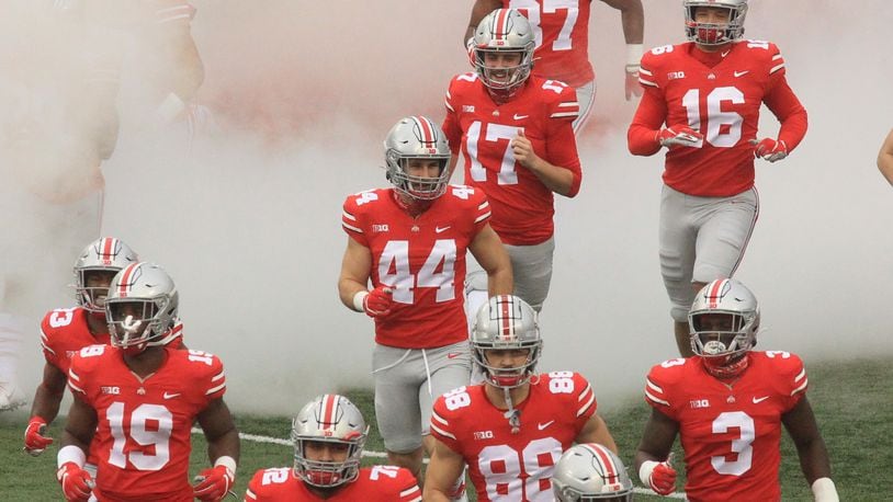 Ohio State players, including Ben Schmiesing (44), take the field before a game against Indiana on Saturday, Nov. 22, 2020, at Ohio Stadium in Columbus. David Jablonski/Staff