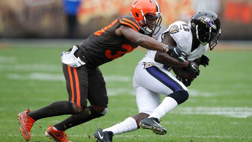 T.J. Carrie #38 of the Cleveland Browns tackles John Brown #13 of the Baltimore Ravens in the first half at FirstEnergy Stadium on October 7, 2018 in Cleveland, Ohio. (Photo by Joe Robbins/Getty Images)