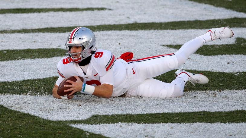 Ohio State quarterback Jack Miller III falls on the ball in the end zone for a safety after the snap went over his head during the second half of an NCAA college football game against Michigan State, Saturday, Dec. 5, 2020, in East Lansing, Mich. (AP Photo/Al Goldis)