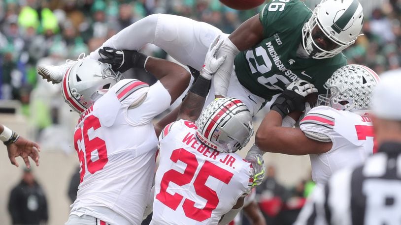 Michigan State’s Brandon Bouyer-Randle goes over Ohio State blockers defending a pass during second-half action Saturday, Nov. 10, 2018, at Spartan Stadium, in East Lansing, Mich. Ohio State won, 26-6. (Kirthmon F. Dozier/Detroit Free Press/TNS)