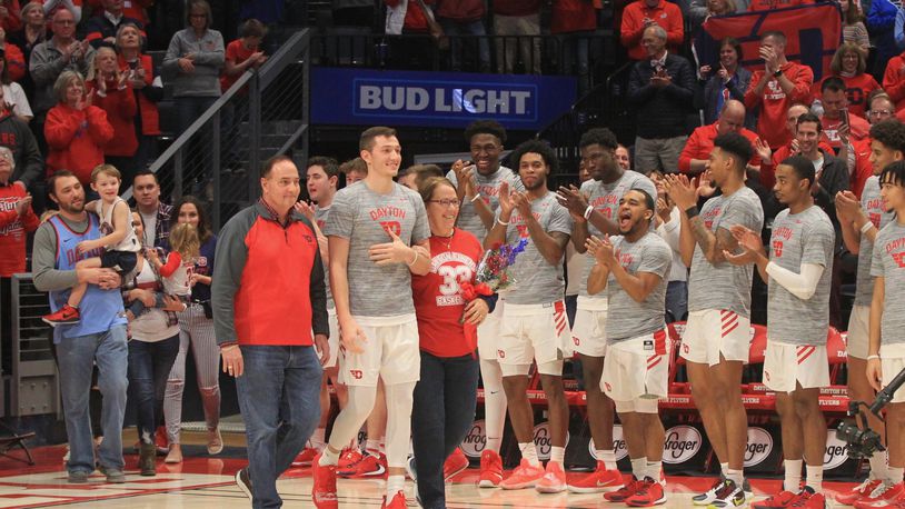 Dayton’s Ryan Mikesell walks onto the court on Senior Night with his parents Reed and Lisa on Saturday, March 7, 2020, at UD Arena. David Jablonski/Staff