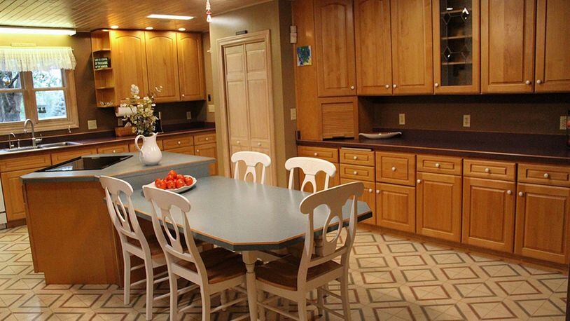 The current kitchen was created by renovating and combining the 2 rooms that held the original kitchen and a separate summer kitchen. Knotty pine was used to panel the ceiling, and recessed ceiling lights were installed.