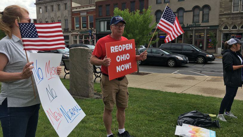 A small group of demonstrators gathered Saturday, June 13, outside the Greene County Courthouse in Xenia to rally for a return to school in the fall without restrictions. This is one of a series of rallies happening across the state. THOMAS GNAU/STAFF
