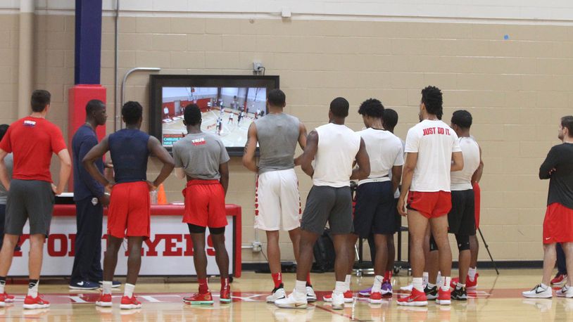 Dayton players watch film with coach Anthony Grant during practice at the Cronin Center on Tuesday, July 31, 2018, in Dayton. David Jablonski/Staff