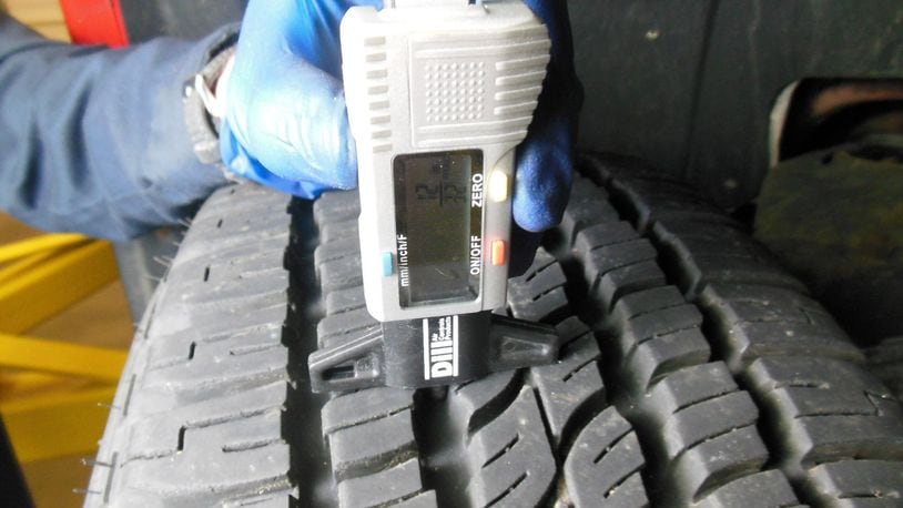 A digital tread depth a-gauge being used to measure the tread depth of tires. Most shops perform a safety check including checking and recording the tread depth of the tires, whenever the vehicle is in the shop for any service or repairs. James Halderman photo