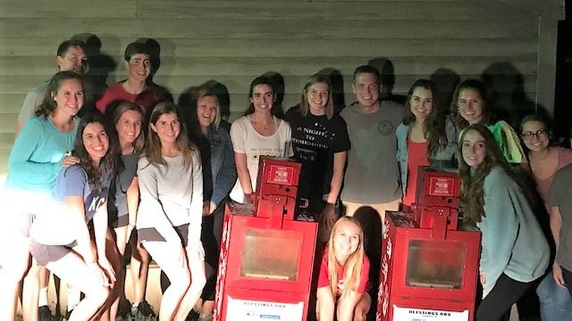 Members of the Miami University Student United Way pose with the Blessing Boxes they established to help provide food to local residents. Similar to the Little Free Library with books, the boxes contain non-perishable food items people free to take if they need food and everyone is invited to place items in them to help others. CONTRIBUTED