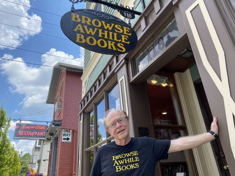 Bill Jones, owner of Browse Awhile Books, stands outside his shop in Tipp City.