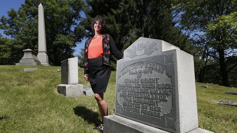 Angie Hoschouer, manager of development and marketing for Woodland Historic Cemetery Arboretum & Foundation, created a tour of area sports legends at the cemetery. One of the stops will be Maggie Doane’s grave. Doan, who died in 1917, was a champion rodeo rider. LISA POWELL / STAFF