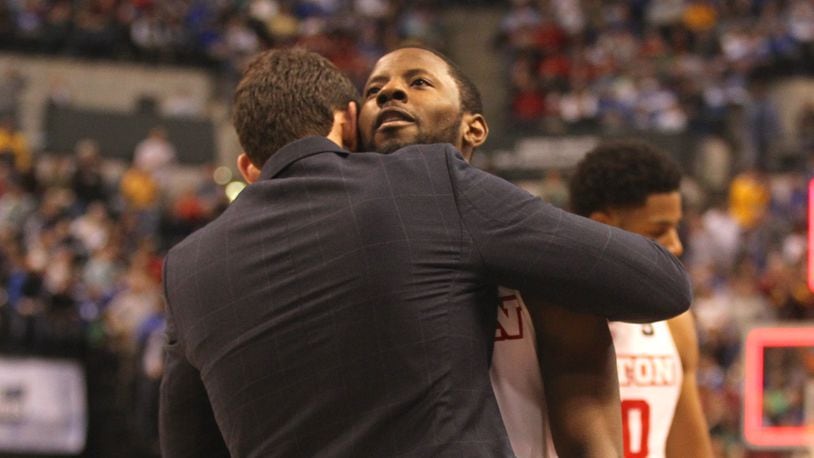 Dayton graduate assistant manager Brian Frank hugs Scoochie Smith after a loss to Wichita State in the NCAA tournament on Friday, March 17, 2017, at Bankers Life Fieldhouse in Indianapolis.