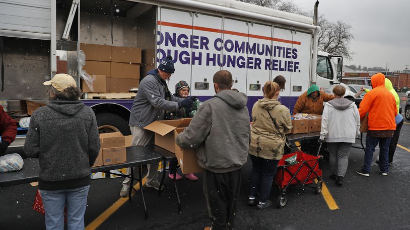 Volunteers pass out food at Second Harvest Food Bank's Mobile Pantry Wednesday, Nov. 16, 2022 in the parking lot of the First United Church of Christ in Springfield. BILL LACKEY/STAFF