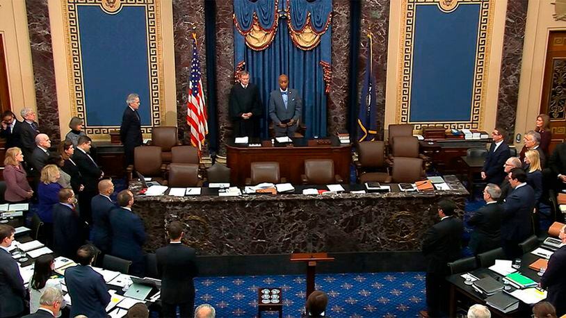 FILE - In this Wednesday, Jan. 29, 2020, file image from video, Senate chaplain and retired Navy Adm. Barry Black gives the opening prayer as presiding officer and Supreme Court Chief Justice John Roberts listens during the impeachment trial against President Donald Trump in the Senate at the U.S. Capitol in Washington. Since the trial began, Black’s prayers have at times sought to guide senators through the political turbulence of the moment.