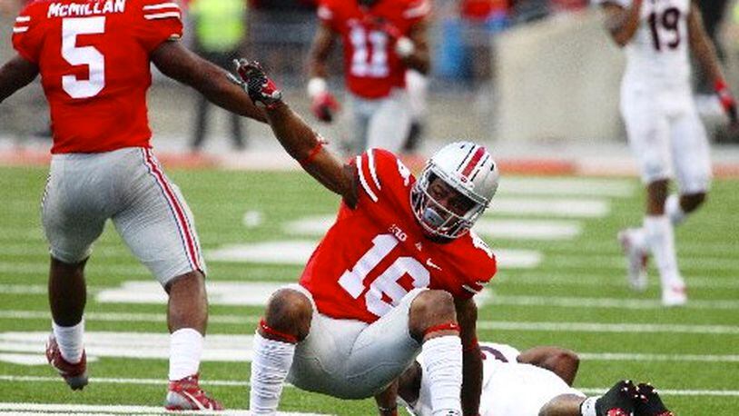 Ohio State safety Cam Burrows gets up after breaking up a fourth-down pass against Northern Illinois on Saturday, Sept. 19, 2015, at Ohio Stadium in Columbus. David Jablonski/Staff