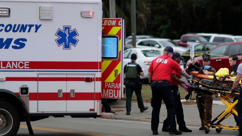 A person is transported from the scene of a shooting at a yoga studio in Tallahassee, Florida, on Friday, Nov. 2, 2018. A gunman killed two women and wounded five others when he opened fire on people inside.